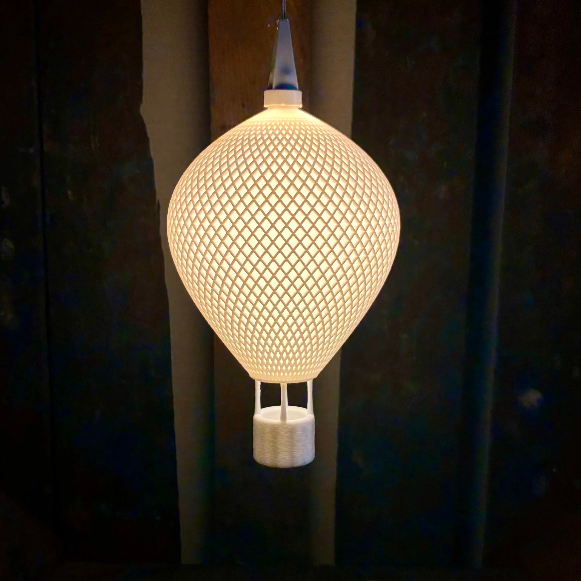 Ovarana Chandni 3D printed pendant lamp lit, glowing through its open lattice shade
