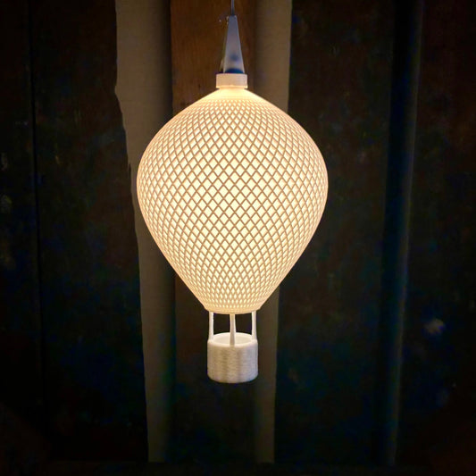 Ovarana Chandni 3D printed pendant lamp lit, glowing through its open lattice shade