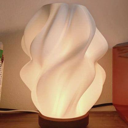 Ovarana Sanjh table lamp lit on a wooden desk beside a pen pot