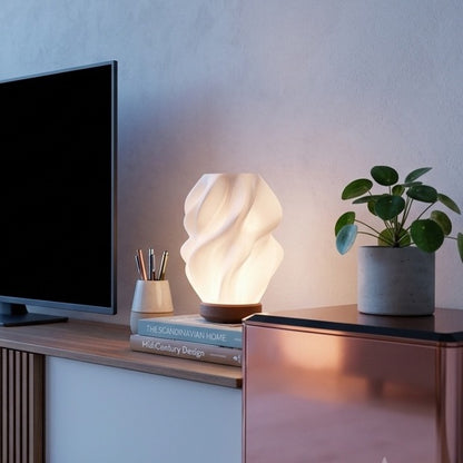 Ovarana Sanjh table lamp lit on a media console at dusk